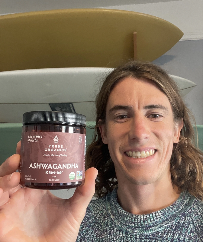 Person holding the Tribe Organic's Ashwagandha Capsules bottle.