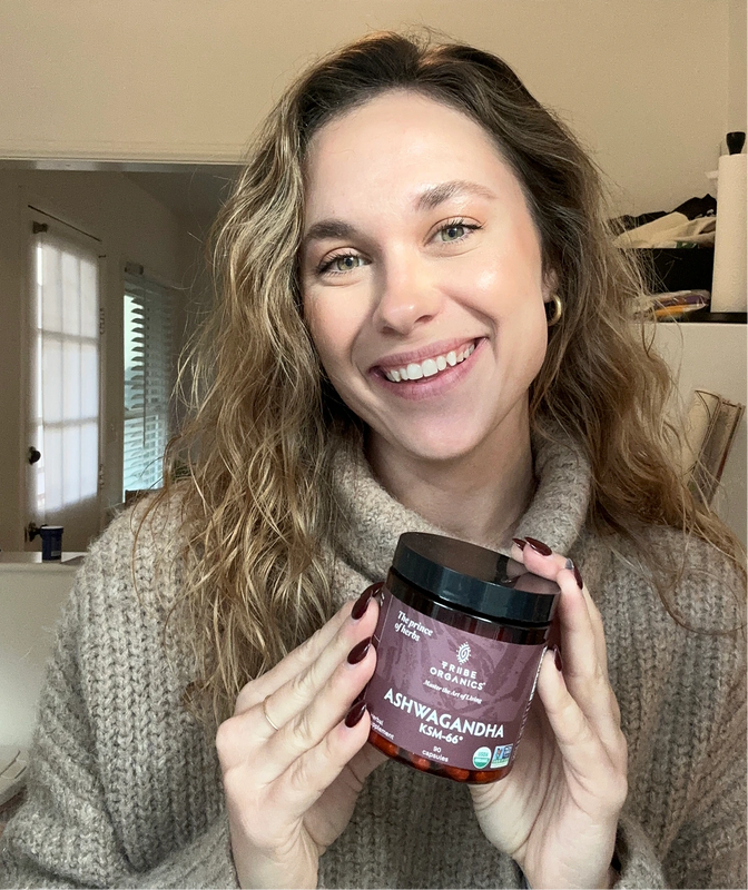 Person holding the Tribe Organic's Ashwagandha Capsules bottle.