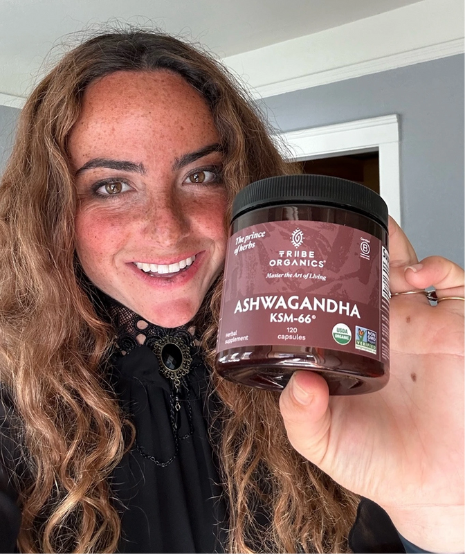 Person holding the Tribe Organic's Ashwagandha Capsules bottle.