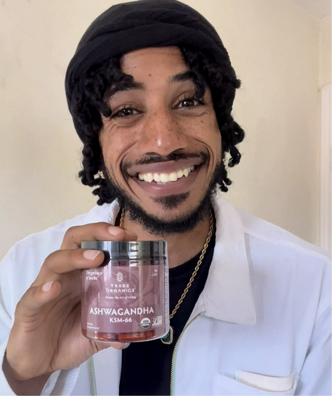 Person holding the Tribe Organic's Ashwagandha Capsules bottle.