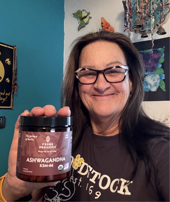 Person holding the Tribe Organic's Ashwagandha Capsules bottle.