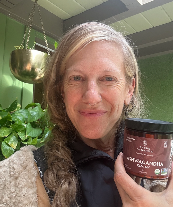 Person holding the Tribe Organic's Ashwagandha Capsules bottle.