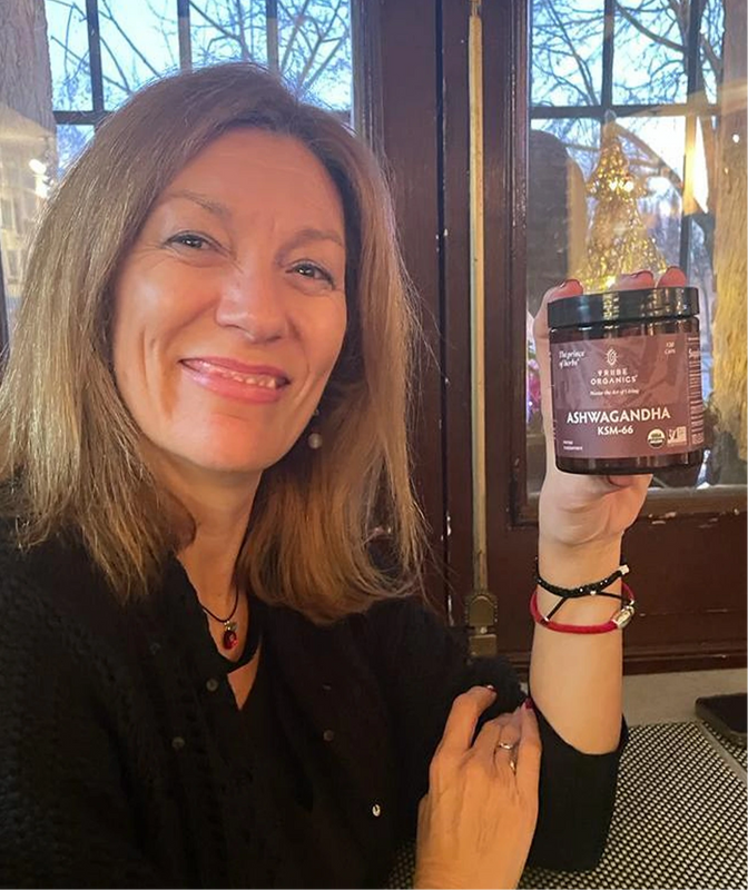 Person holding the Tribe Organic's Ashwagandha Capsules bottle.